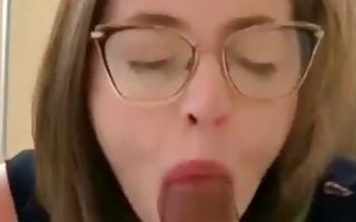 Geeky babe swallowing his giant and erect cock