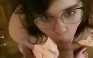 Geeky brunette blowing off a huge and fat cock